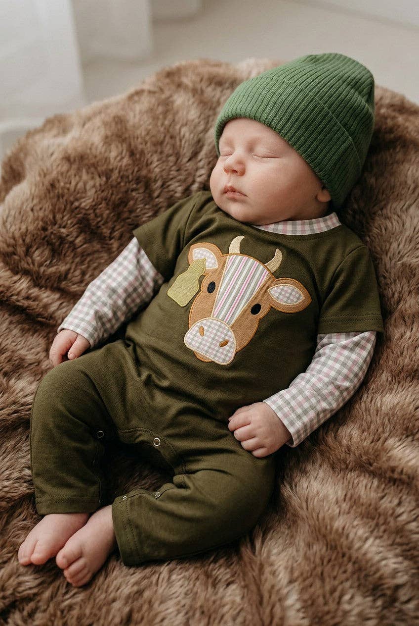 Bull applique on green baby romper.