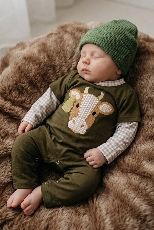 Bull applique on green baby romper.